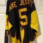 The back of the black and yellow ICP jersey with the number 5, and Jake Jeckel on the nameplate.
