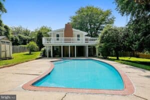 There's a lot to consider when you're trying to figure out how to choose the right estate liquidation option for a house you're leaving or one that you inherited. This photo of the back of a home with a big patio deck and swimming pool used to be owned by people who may not have done it the right way.