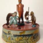 A vintage Louis Marx windup tin toy features a circus ringmaster , vlown, monkey and an elephant.