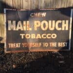 Vintage black and white Mail Pouch Tobacco sign looks great even in old age.