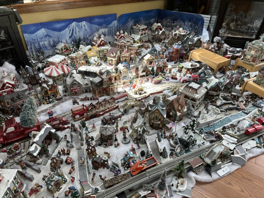 A massive collection of Department 56 Christmas villages and figurines sprawls across a living room floor -- on display and junking up the house 12 months out of the year.