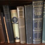 A few rare books including an older edition of Walden by Henry David Thoreau sit on a bookshelf.