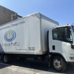 A white A Wider Circle box truck is poised for the next call from people with furniture to donate.