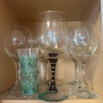 A few worthless wine glasses sit in a kitchen cabinet. They're not worth selling on Facebook Marketplace.