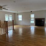 A photos of a large, clean, shiny living room after Orion's Attic did our thing.