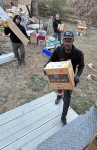 Estate cleanout team loading sorted items for donation, sale, and recycling.