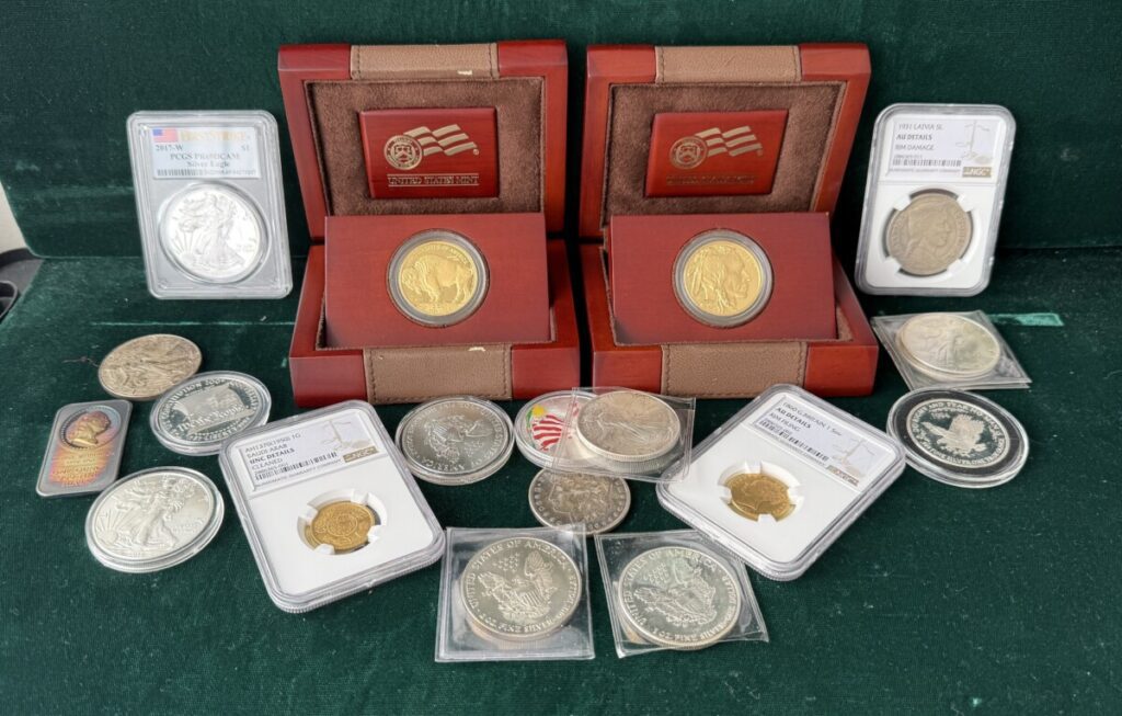 An array of gold and silver coins including gold proof coins, sterling proof coins and graded coins.