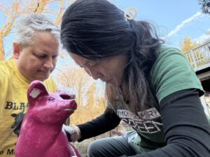 Won-ok Kim restoring cement pig during estate liquidation and home cleanout project in Maryland