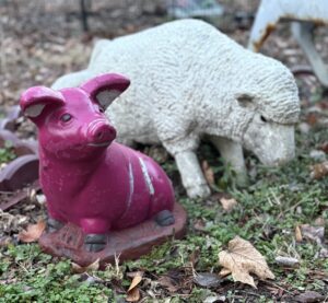 Restored cement pig with other yard animals after estate cleanout in Maryland