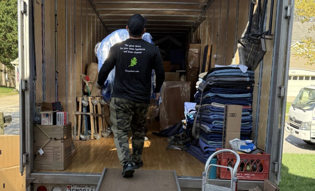 An Orion's Attic team member walks a piece of furniture up the ramp of one of our trucks during as part of the Montgomery County moving services we provide.
